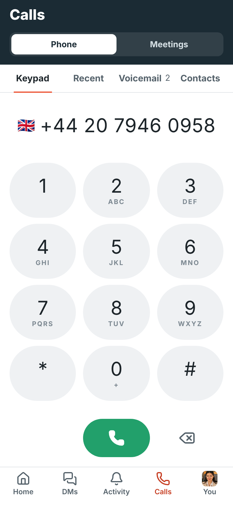 The keypad with a London number typed: a UK flag next to +44 20 7946 0958, over large keys that fill the screen